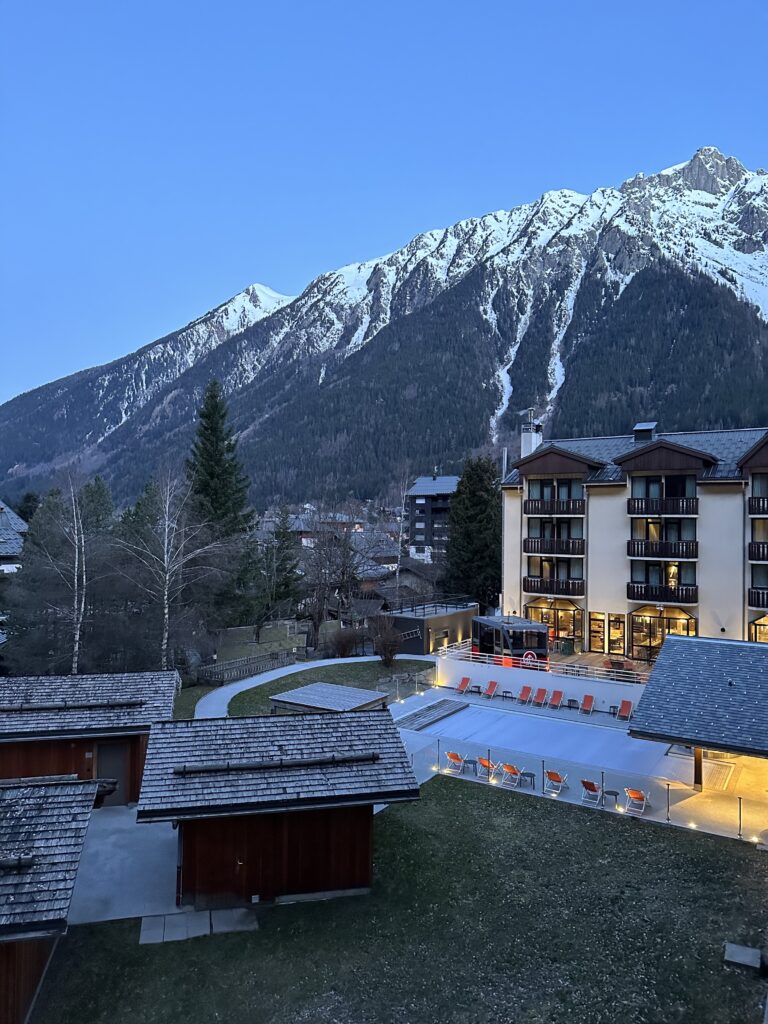 View of the French Alps, swimming pool and sauna from the balcony of hotel room at Le Refuge des Aiglons.